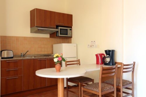Fully equipped kitchenette at Panthea Holiday Village in Ayia Napa, Cyprus. Travel with World Lifetime Journeys