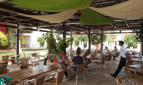 Outdoor terrace at Panthea Holiday Village in Ayia Napa, Cyprus. Travel with World Lifetime Journeys