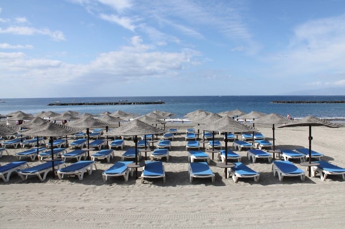 Sunbeds on La Caleta beach near Costa Adeje, Tenerife. Travel with World Lifetime Journeys