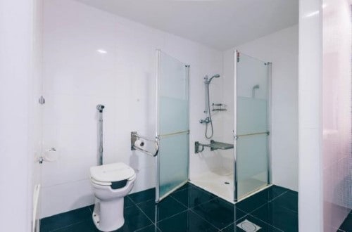 Bathroom with shower at Muthu Raga Madeira Hotel in Madeira, Portugal. Travel with World Lifetime Journeys