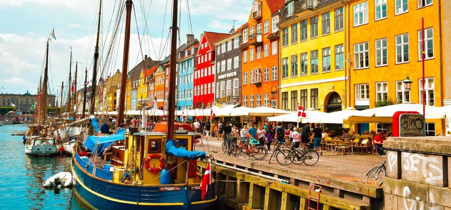 Copenhagen boats and city view. Travel with World Lifetime Journeys
