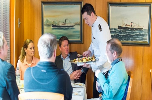 Enjoy a meal on MS Lofoten on Norway Voyages. Travel with World Lifetime Journeys