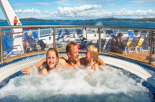 Family in Jacuzzi on MS Finnmarken on Norway Voyages. Travel with World Lifetime Journeys