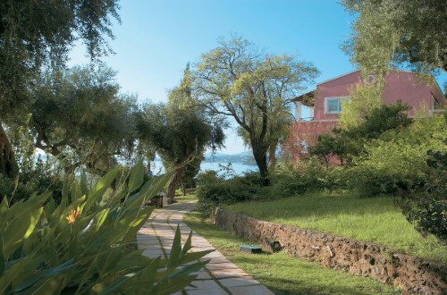 Garden patio at Grecotel Eva Palace in Corfu, Greece. Travel with World Lifetime Journeys