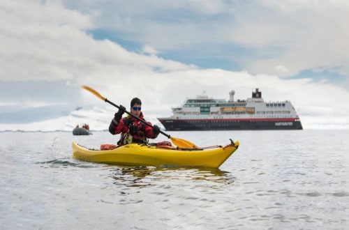 Kayaking near MS Midnatsol on Norway Voyages. Travel with World Lifetime Journeys