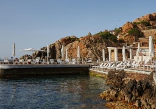 Lounges by the sea at Cefalu Resort, Sicily. Travel with World Lifetime Journeys