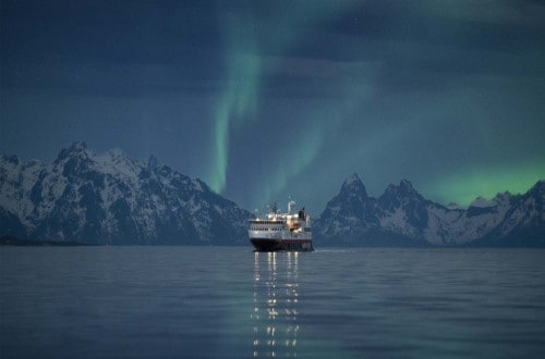 MS Spitsbergen under the Northern Lights in Norway on Northern Lights round voyage. Travel with World Lifetime Journeys