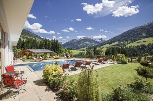 Outdoor pool at Hotel Alpbacherhof in Alpbach, Austria. Travel with World Lifetime Journeys