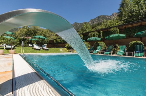 Outdoor pool at Romantik Hotel Boglerhof in Alpbach, Austria. Travel with World Lifetime Journeys
