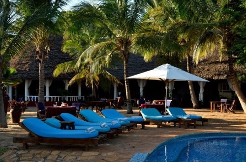 Pool lounges at Fumba Beach Lodge, Zanzibar. Travel with World Lifetime Journeys