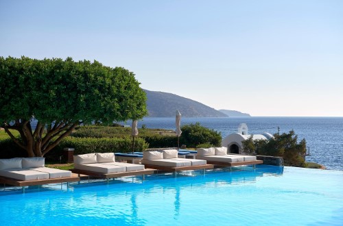 Pool side at St. Nicolas Bay Resort Hotel & Spa in Agios Nikolaos, Crete. Travel with World Lifetime Journeys