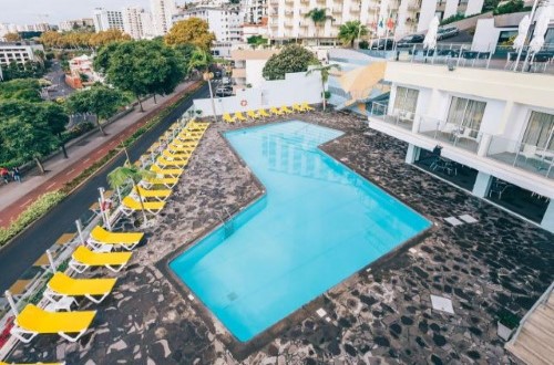 Pool view at Muthu Raga Madeira Hotel in Madeira, Portugal. Travel with World Lifetime Journeys