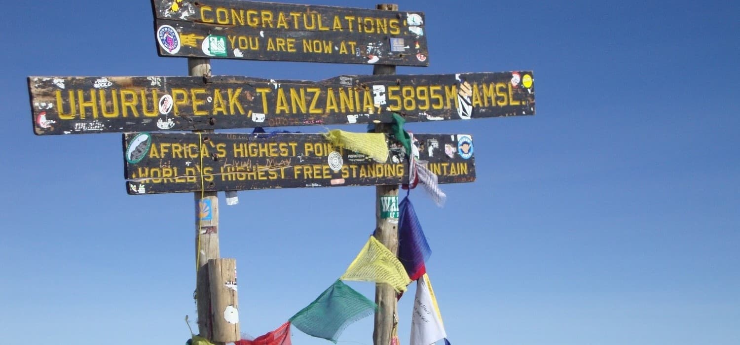 Reaching the top of Kilimanjaro mountain, Tanzania. Travel with World Lifetime Journeys