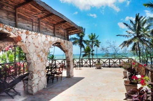 Relax with a drink on the terrace at Samaki Lodge, Zanzibar. Travel with World Lifetime Journeys