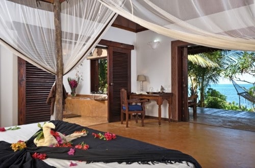 Romantic bedroom at Fumba Beach Lodge, Zanzibar. Travel with World Lifetime Journeys