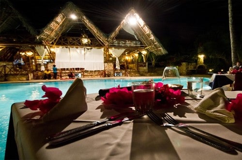 Romantic dinner by the pool at Samaki Lodge, Zanzibar. Travel with World Lifetime Journeys