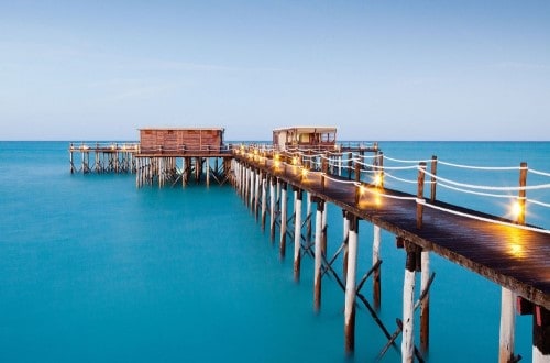 Sunset on the deck at Essque Zalu, Zanzibar. Travel with World Lifetime Journeys