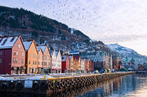 The historic Bryggen district dates back to the 14th century on Northern Lights round voyage. Travel with World Lifetime Journeys