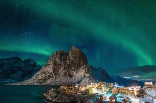 The northern lights over Hamnøy, Lofoten on Northern Lights round voyage. Travel with World Lifetime Journeys