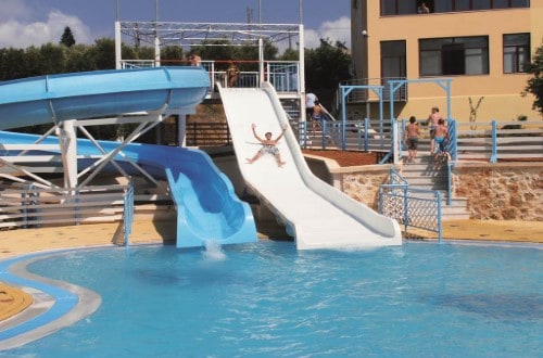 Water slides at Bellos Hotel Apartments in Crete, Greece. Travel with World Lifetime Journeys