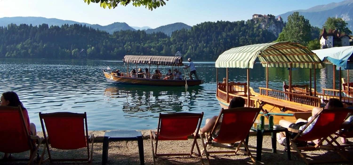 Relax on the shore of Lake Bled, Slovenia. Travel with World Lifetime Journeys