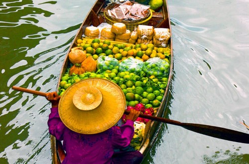 Seller in Thailand floating market. Travel with World Lifetime Journeys