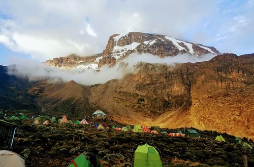 Beautiful view of Kilimanjaro with tents. Travel with World Lifetime Journeys