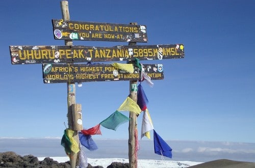 Reaching the top of Kilimanjaro Mountain, Tanzania. Travel with World Lifetime Journeys